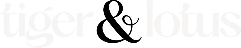 Black large ampersand logomark of tiger & lotus